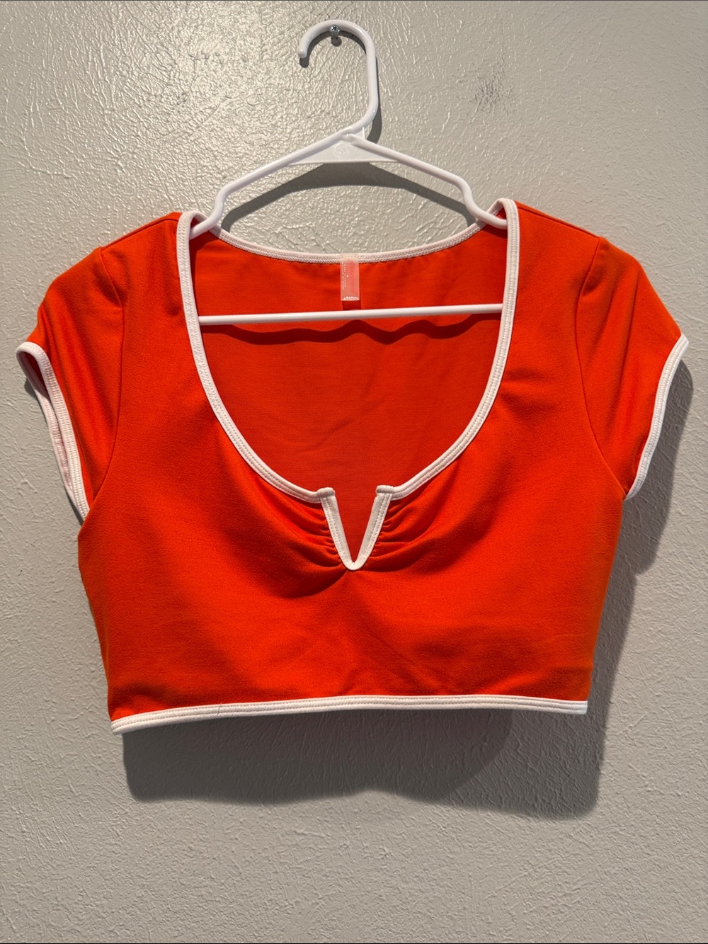 FP Movement by Free People Pitted Orange Cap Sleeve Crop with White Trim.